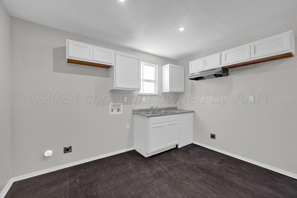 2103 North Marrs Street Amarillo, TX 79107 - Photo 6 of 11 a room with a refrigerator and a sink