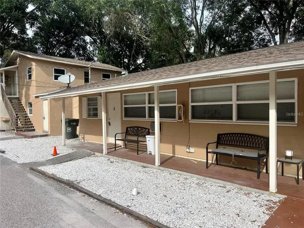 a front view of a house with a yard glass top table and chairs