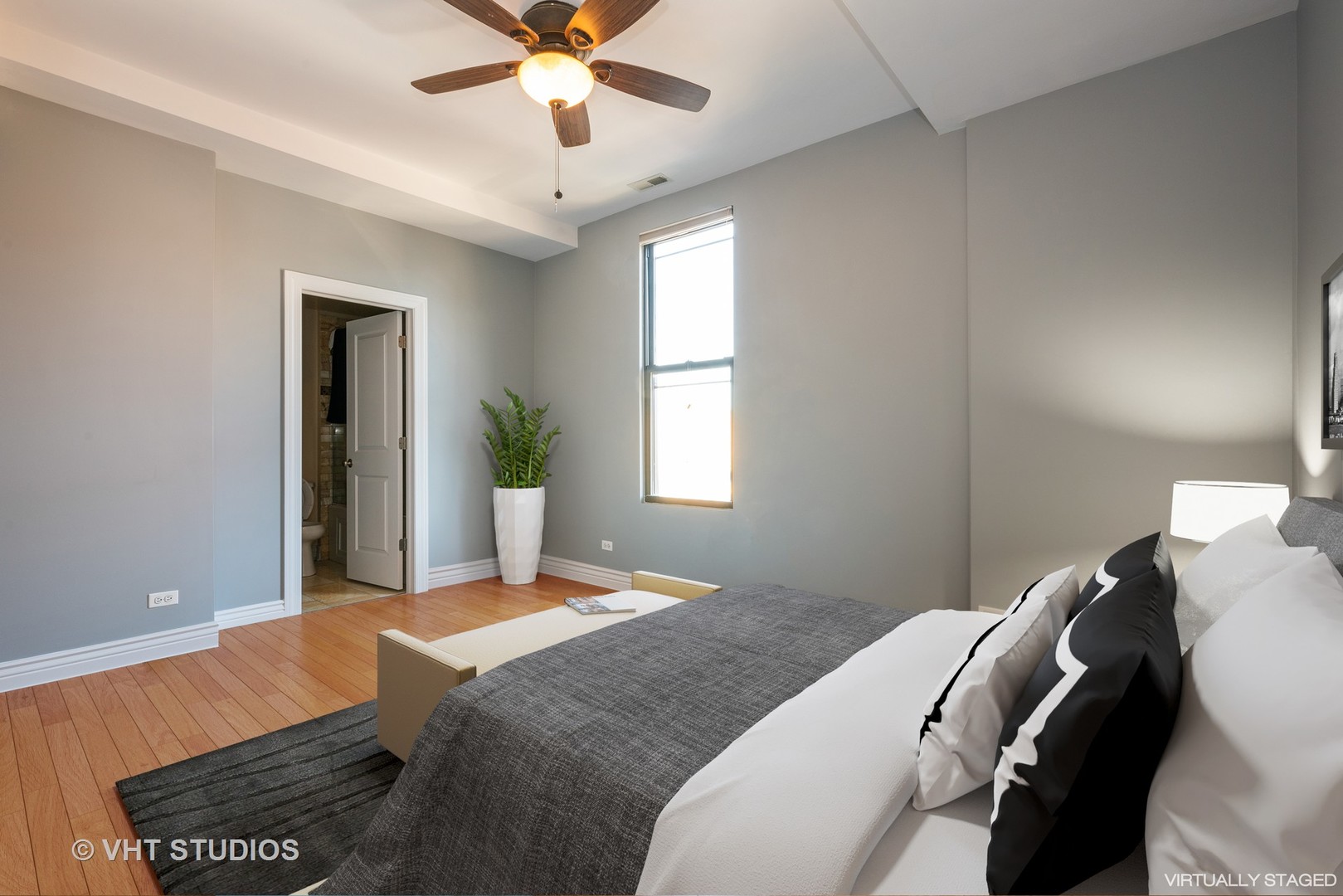 3258 North Racine Avenue, Unit 3 Chicago, IL 60657 - Photo 12 of 19 a bedroom with a bed and a chandelier