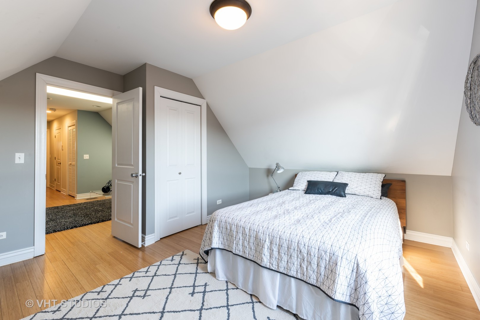 3258 North Racine Avenue, Unit 3 Chicago, IL 60657 - Photo 17 of 19 a bedroom with a bed and a mirror