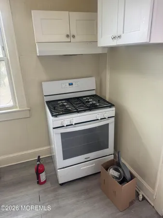 a stove top oven sitting inside of a kitchen
