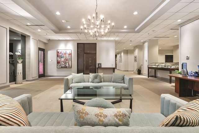 a living room with furniture and a chandelier