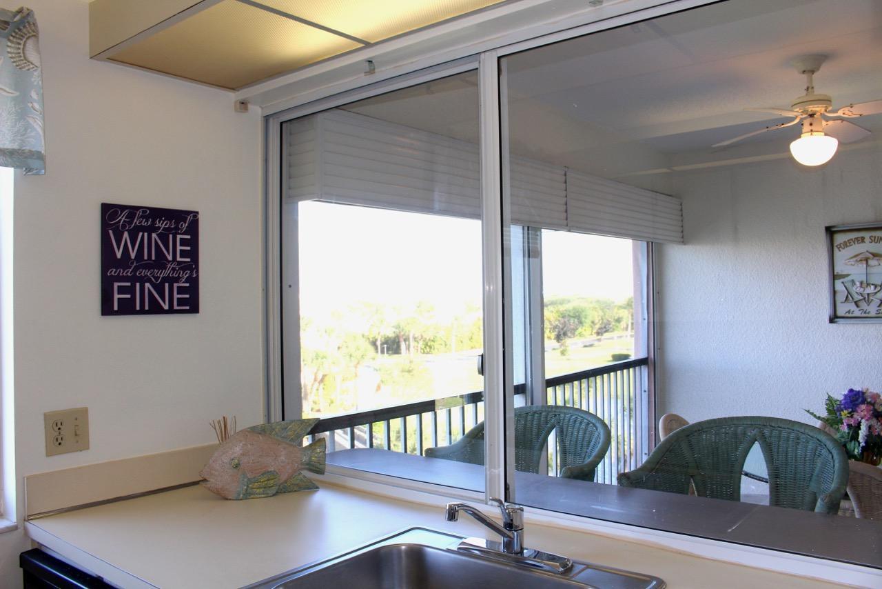 353 Highway 1, Unit F408 Jupiter, FL 33477 - Photo 6 of 27 Jupiter Bay 408 kitchen to balcony