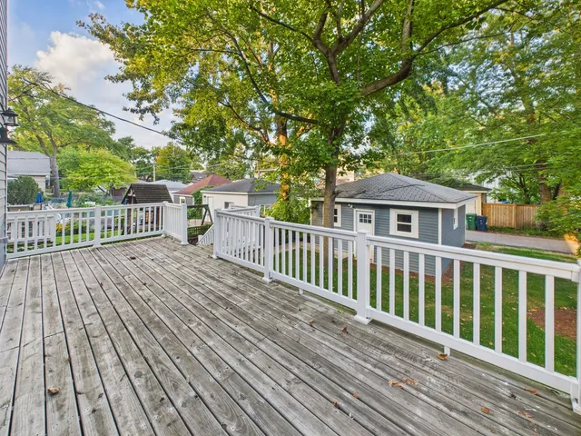 a view of a wooden deck and a yard
