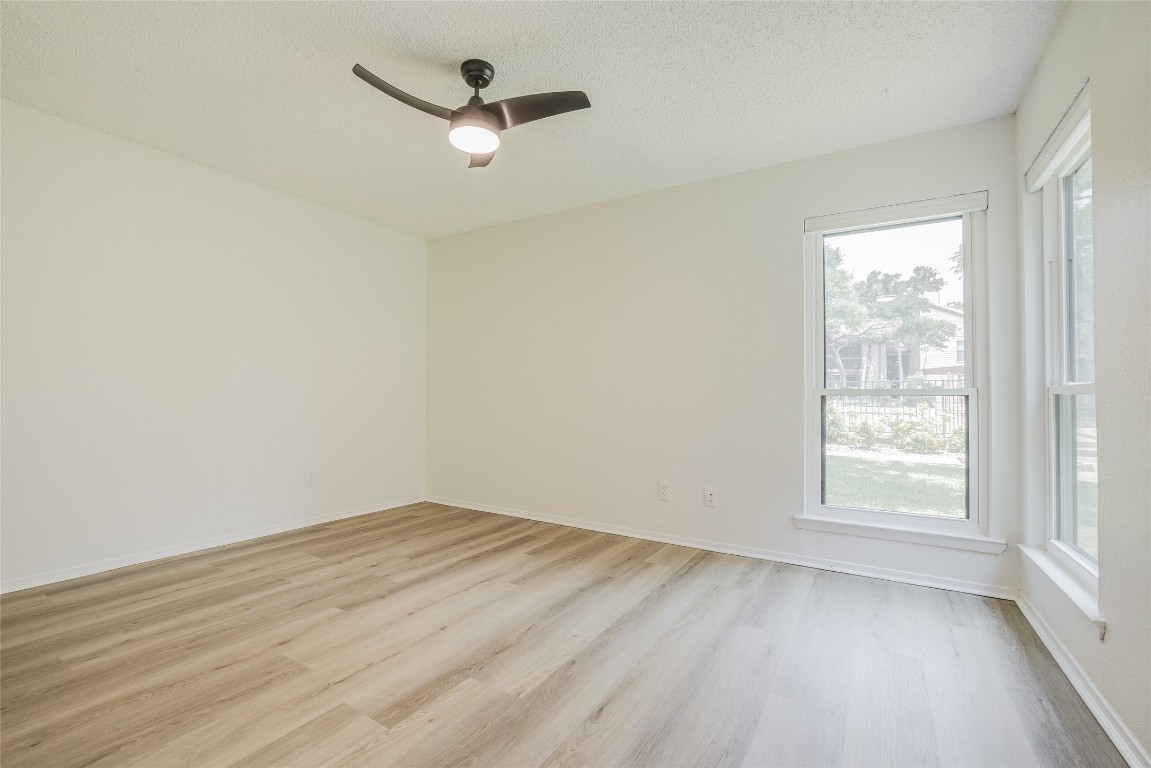 8600 Fathom Circle, Unit 1303 Austin, TX 78750 - Photo 21 of 30 an empty room with a window and a fan