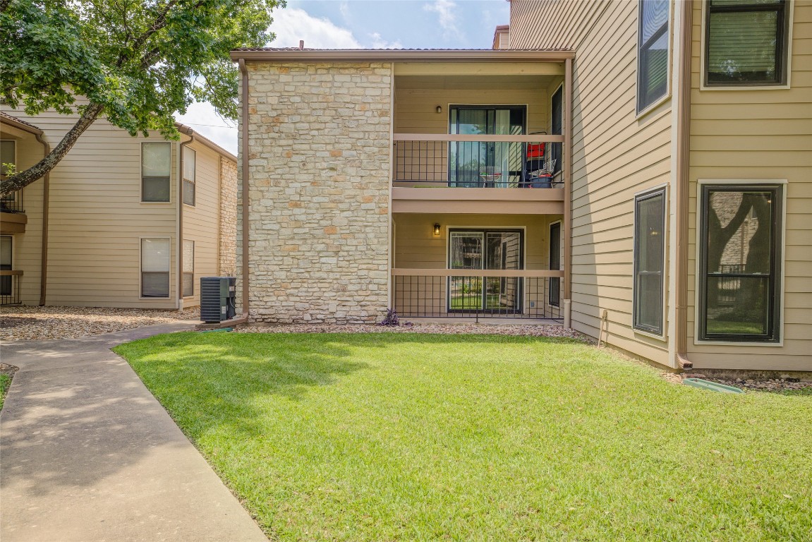 8600 Fathom Circle, Unit 1303 Austin, TX 78750 - Photo 27 of 30 a view of a house with backyard and porch