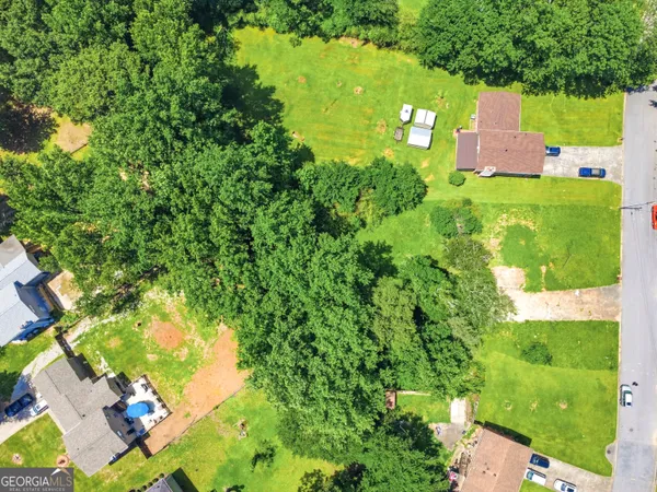 an aerial view of a house with a yard and lake view