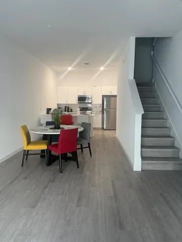 a dining room with furniture and wooden floor