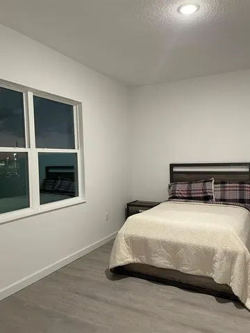 a bedroom with a bed and a window