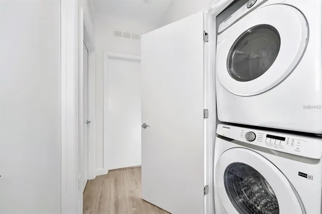 a view of a hallway with washer and dryer