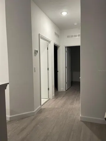 an empty room with closet and a bathroom