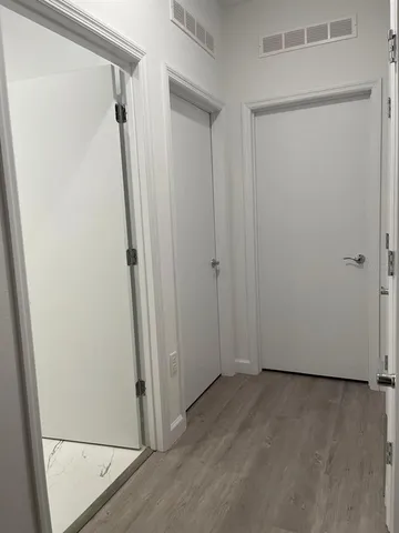 a view of walk in closet with wooden floor