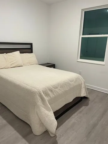 a bedroom with a bed and a window