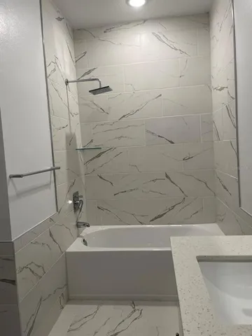 a bathroom with a bathtub and a shower