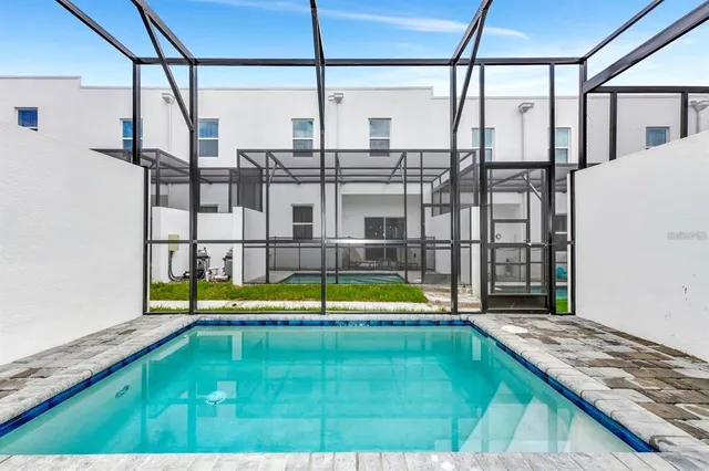 a house view with swimming pool