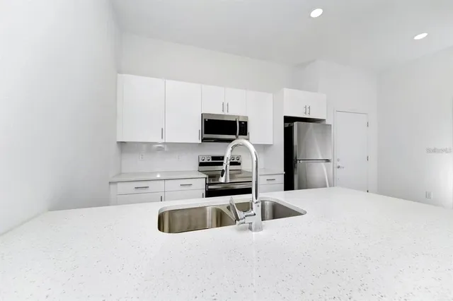 a kitchen with a sink a stove and refrigerator