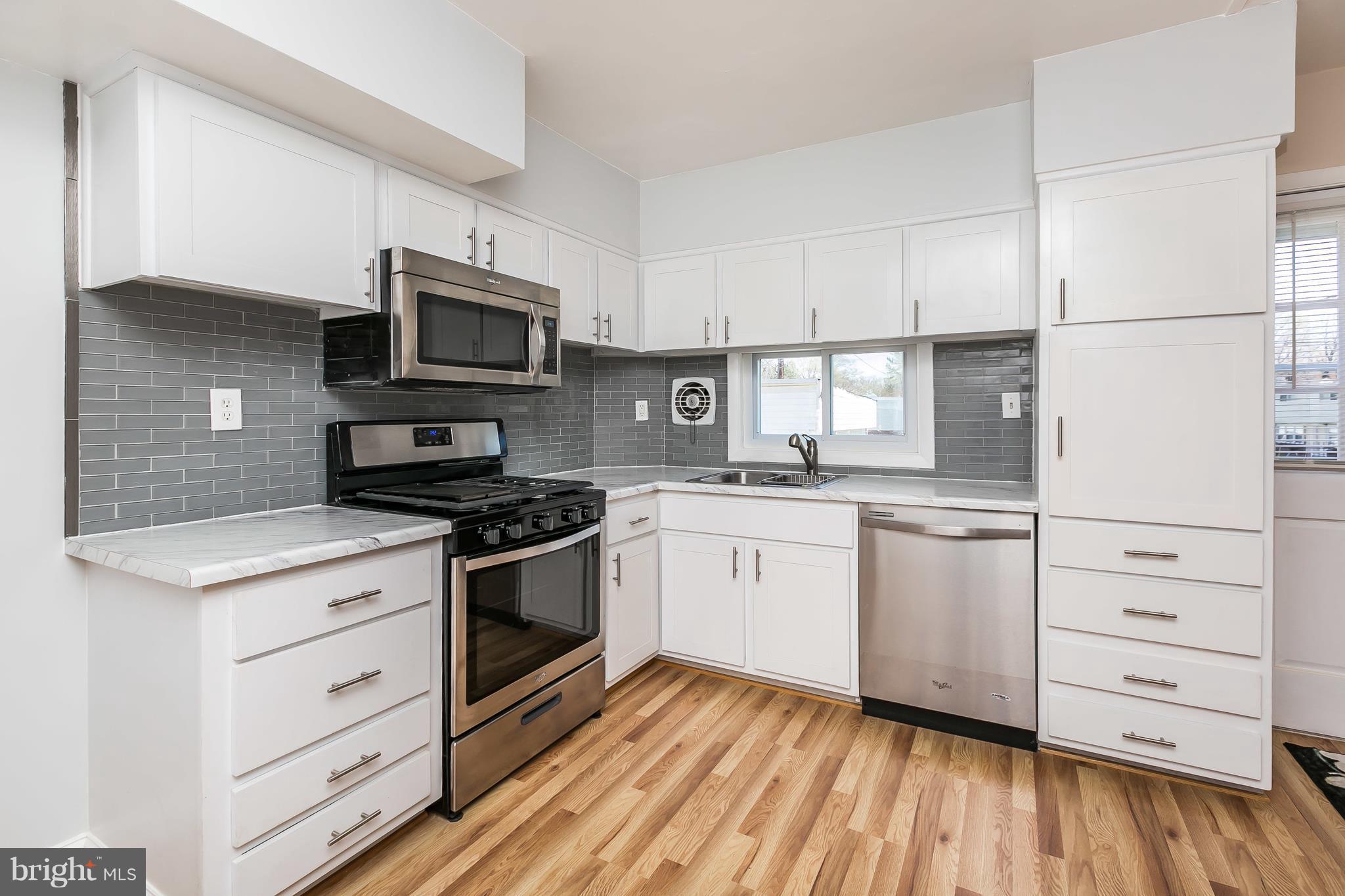 1693 Poles Road Baltimore, MD 21221 - Photo 1 of 19 a kitchen with granite countertop white cabinets and stainless steel appliances