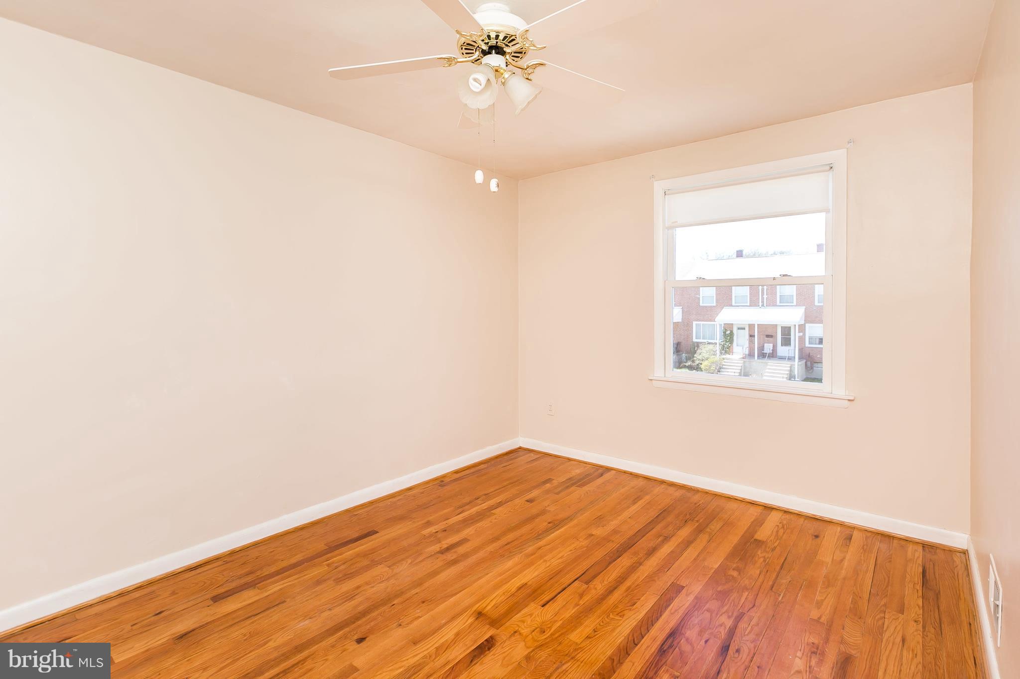 1693 Poles Road Baltimore, MD 21221 - Photo 12 of 19 an empty room with wooden floor closet and windows