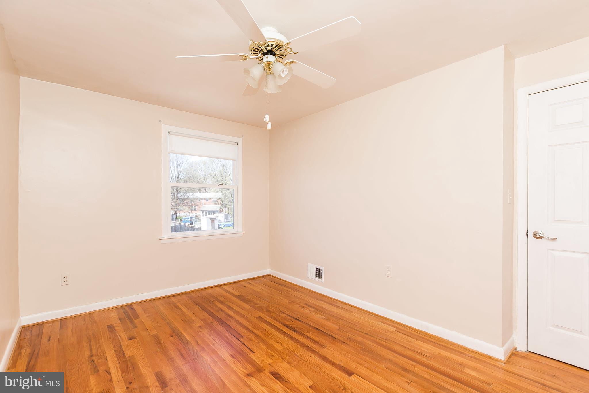 1693 Poles Road Baltimore, MD 21221 - Photo 13 of 19 a view of an empty room with window and wooden floor