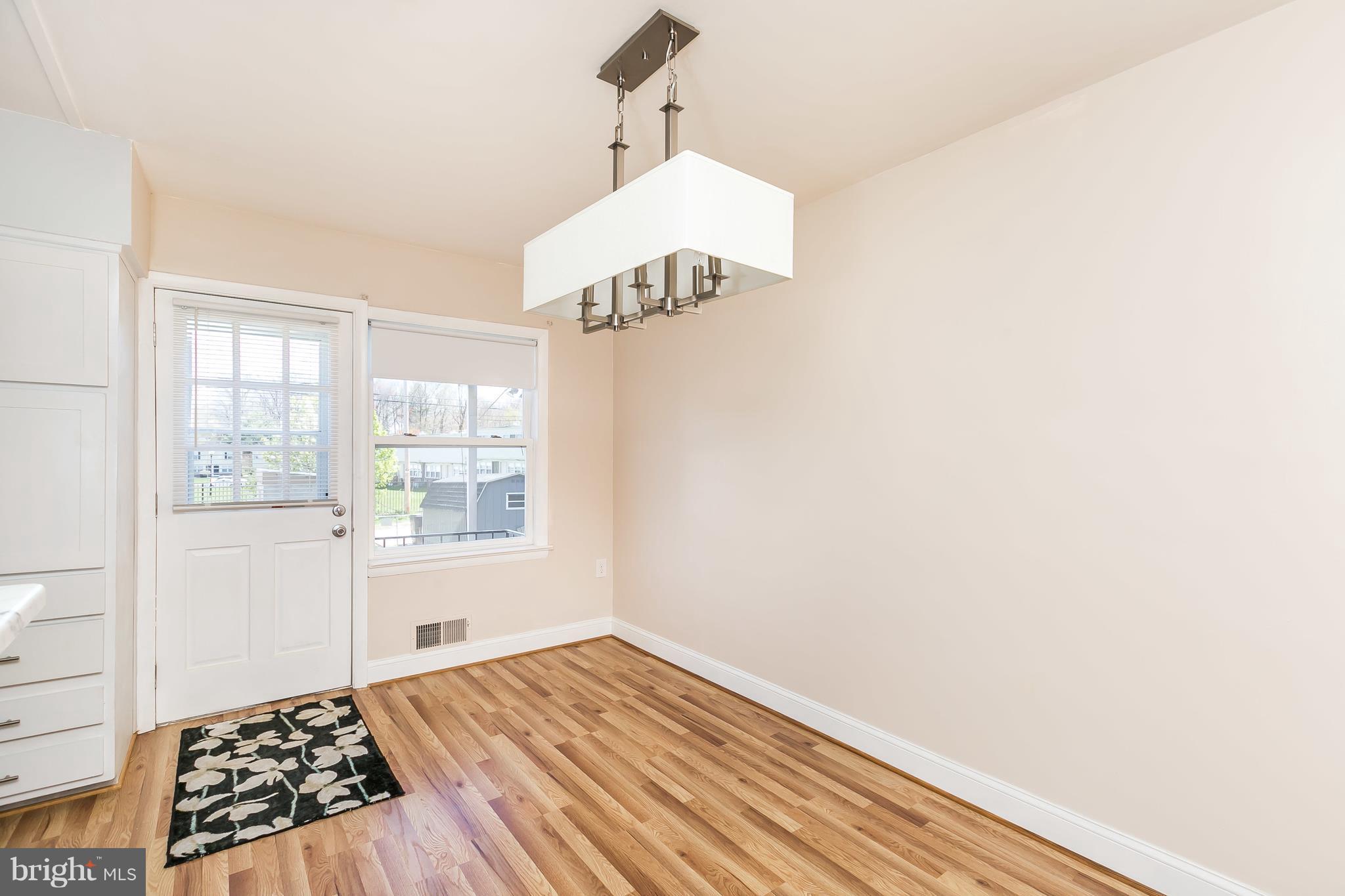 1693 Poles Road Baltimore, MD 21221 - Photo 6 of 19 a view of an empty room with wooden floor and a window
