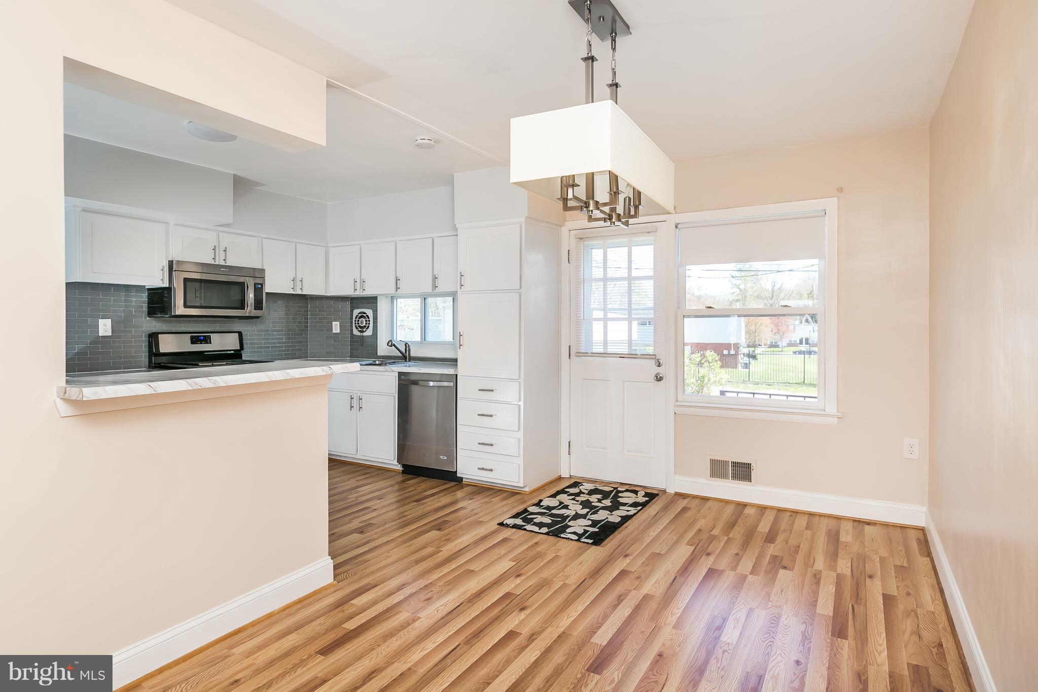 1693 Poles Road Baltimore, MD 21221 - Photo 7 of 19 a kitchen with kitchen island granite countertop a stove a sink and a refrigerator