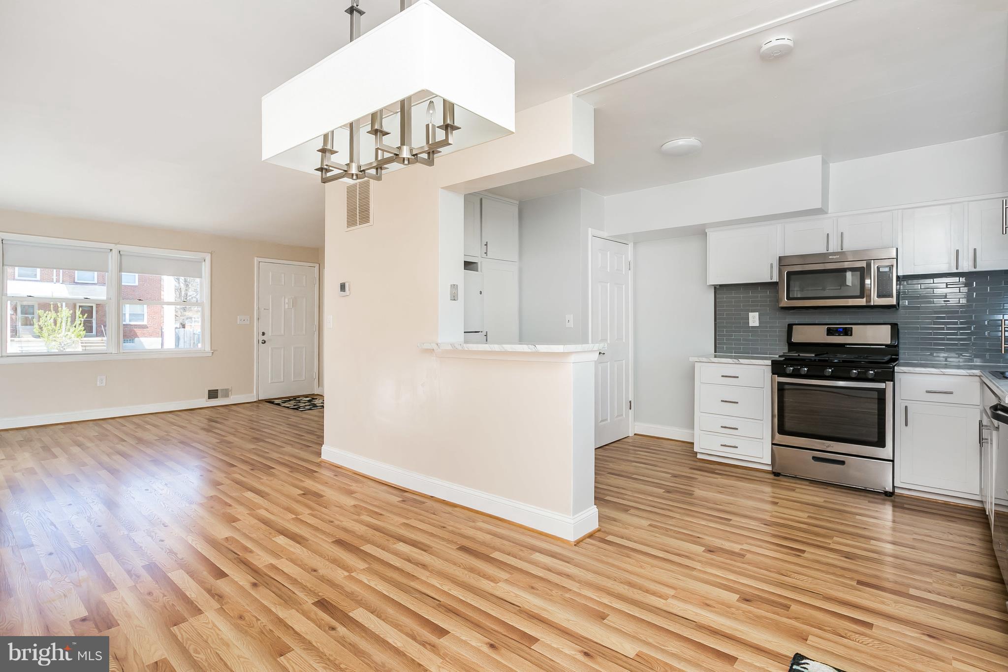 1693 Poles Road Baltimore, MD 21221 - Photo 8 of 19 a kitchen with stainless steel appliances a refrigerator and a stove top oven