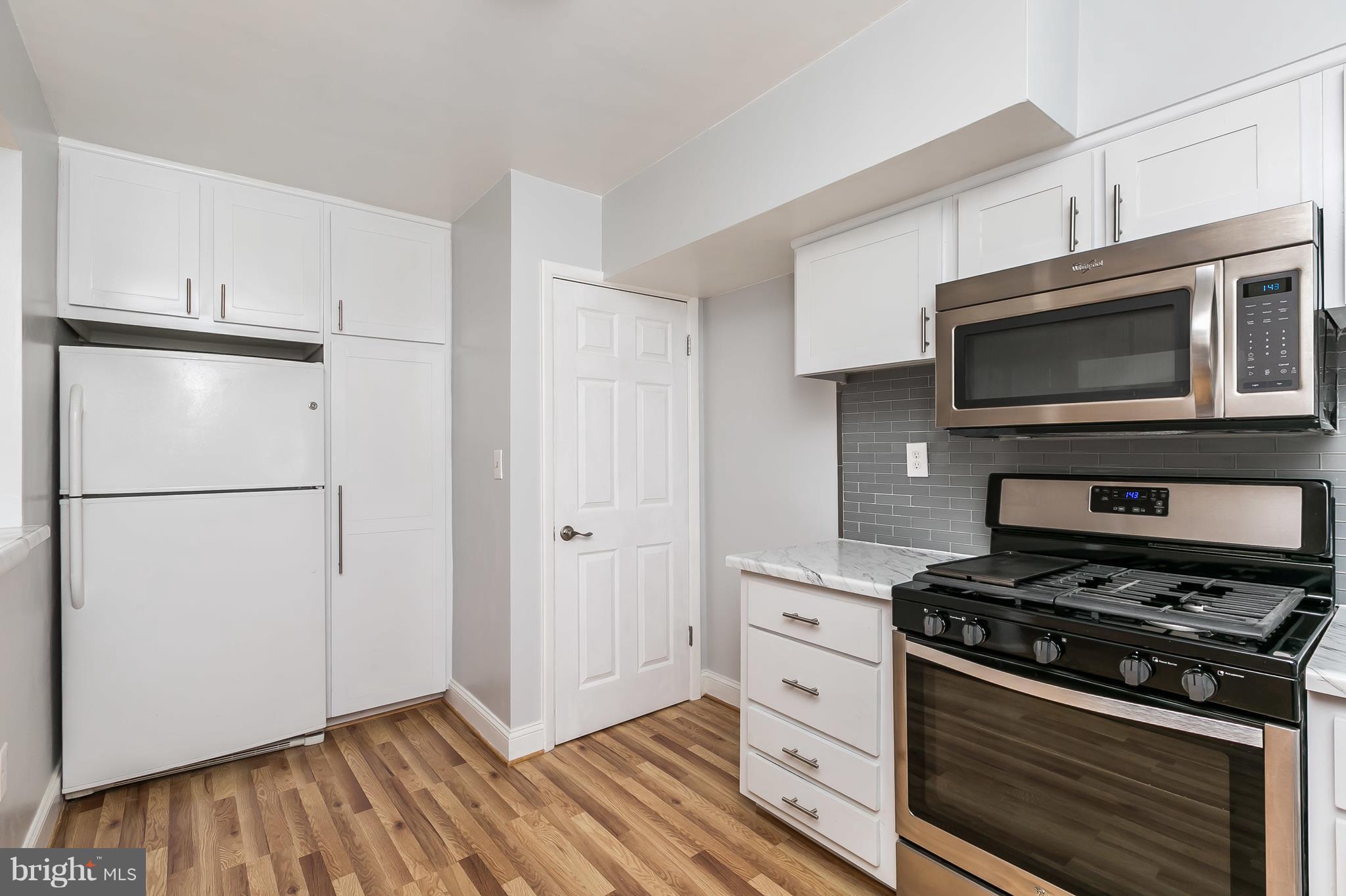 1693 Poles Road Baltimore, MD 21221 - Photo 10 of 19 a kitchen with stainless steel appliances a stove a microwave and a refrigerator