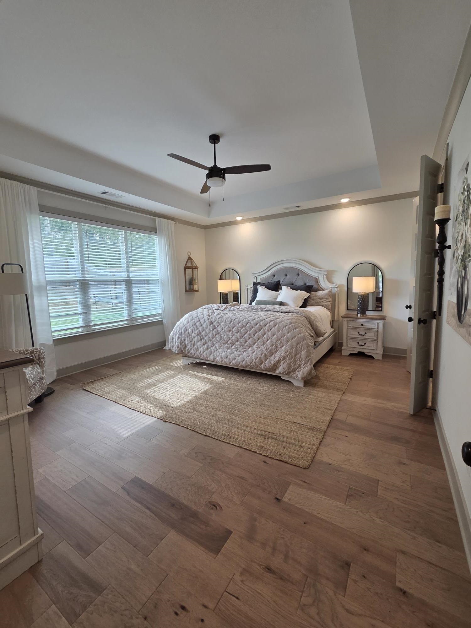 657 Mount Laurel Drive Collierville, TN 38017 - Photo 18 of 40 a spacious bedroom with a bed mirror and window
