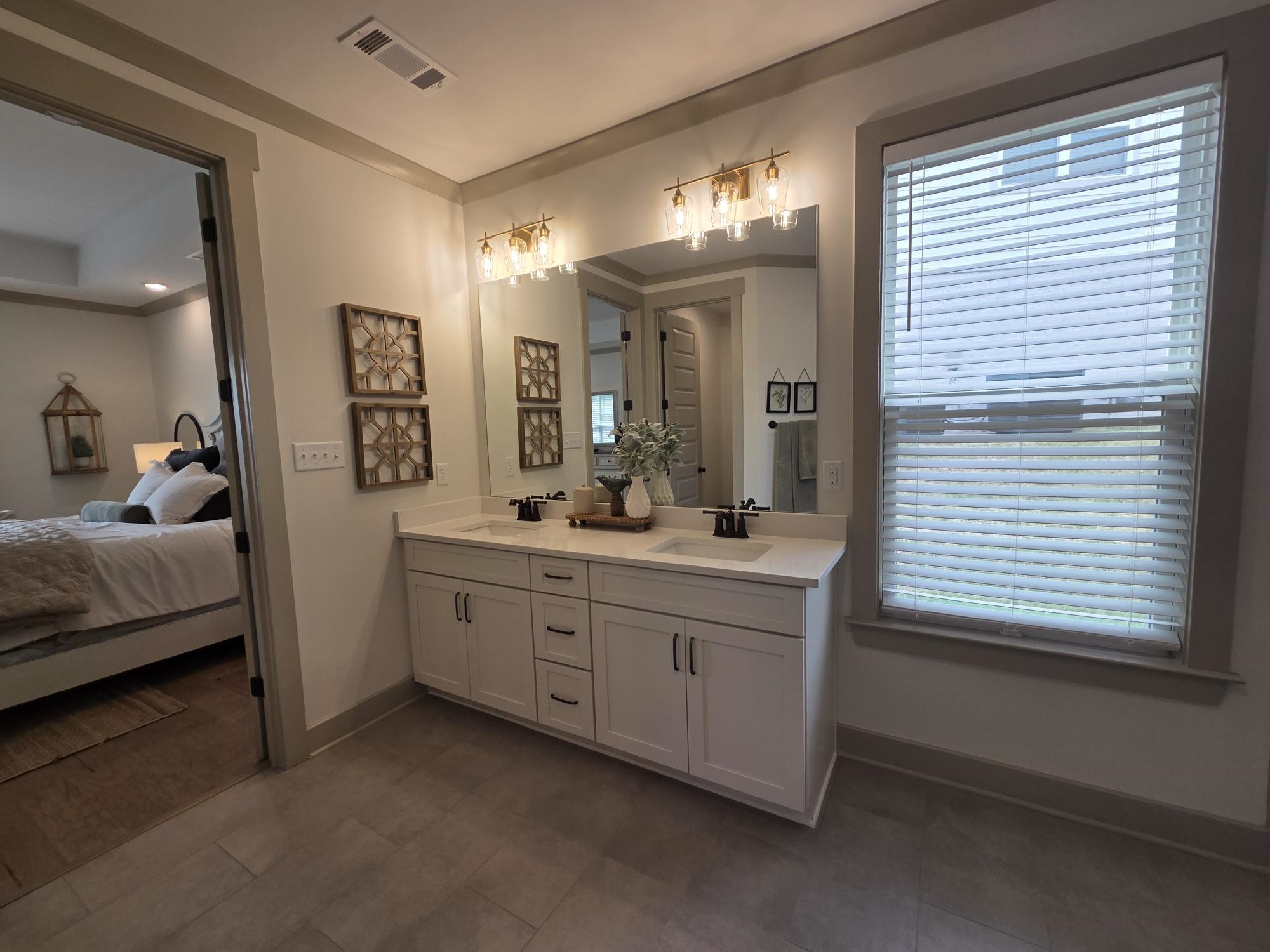 657 Mount Laurel Drive Collierville, TN 38017 - Photo 23 of 40 a spacious bathroom with a double vanity sink and a mirror