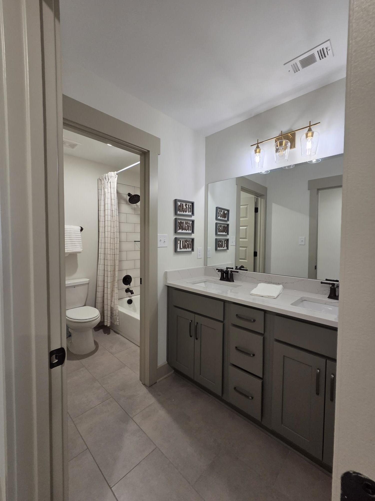 657 Mount Laurel Drive Collierville, TN 38017 - Photo 34 of 40 a spacious bathroom with a granite countertop sink mirror and toilet