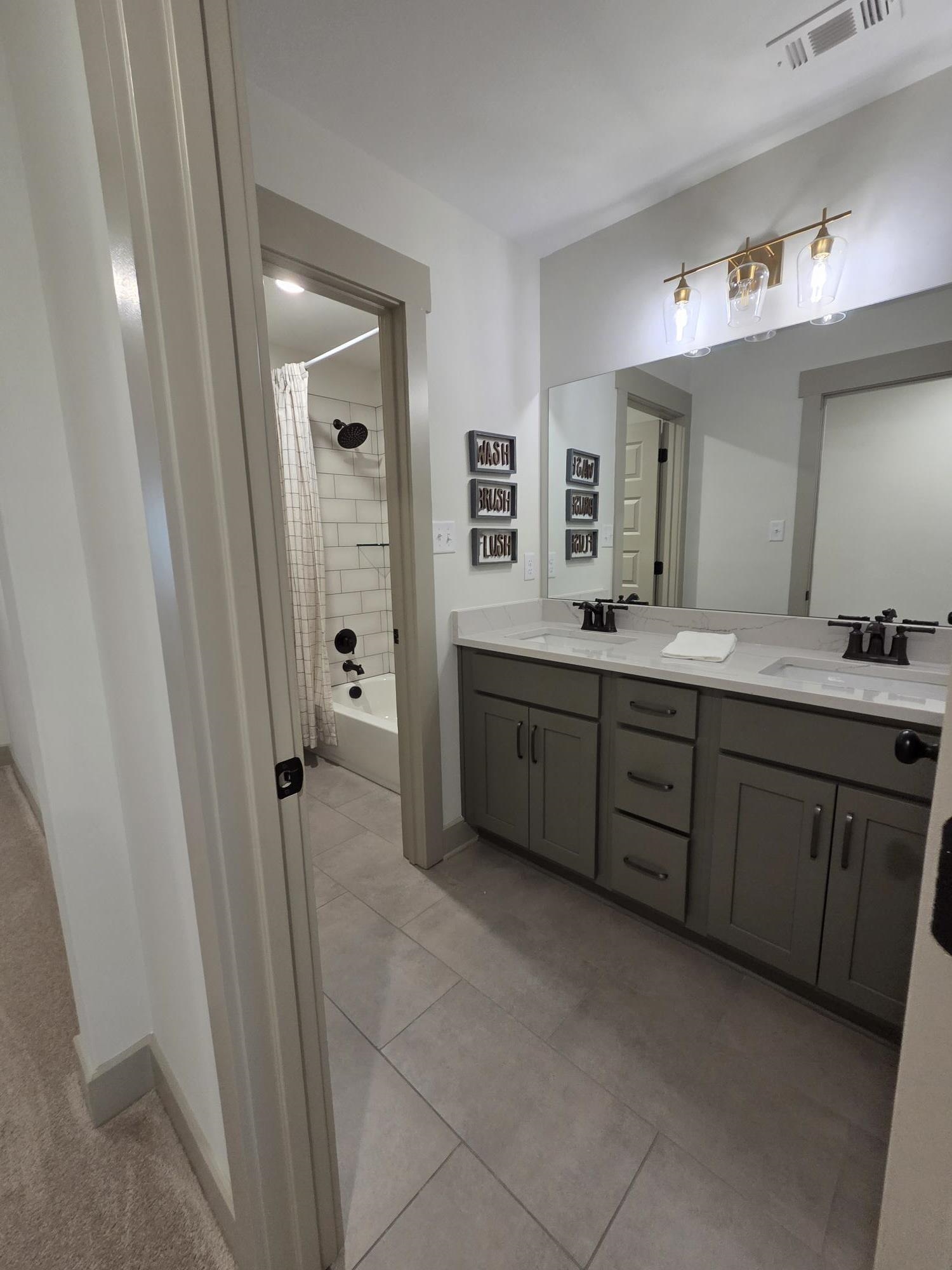 657 Mount Laurel Drive Collierville, TN 38017 - Photo 35 of 40 a spacious bathroom with a double vanity sink a mirror and a shower