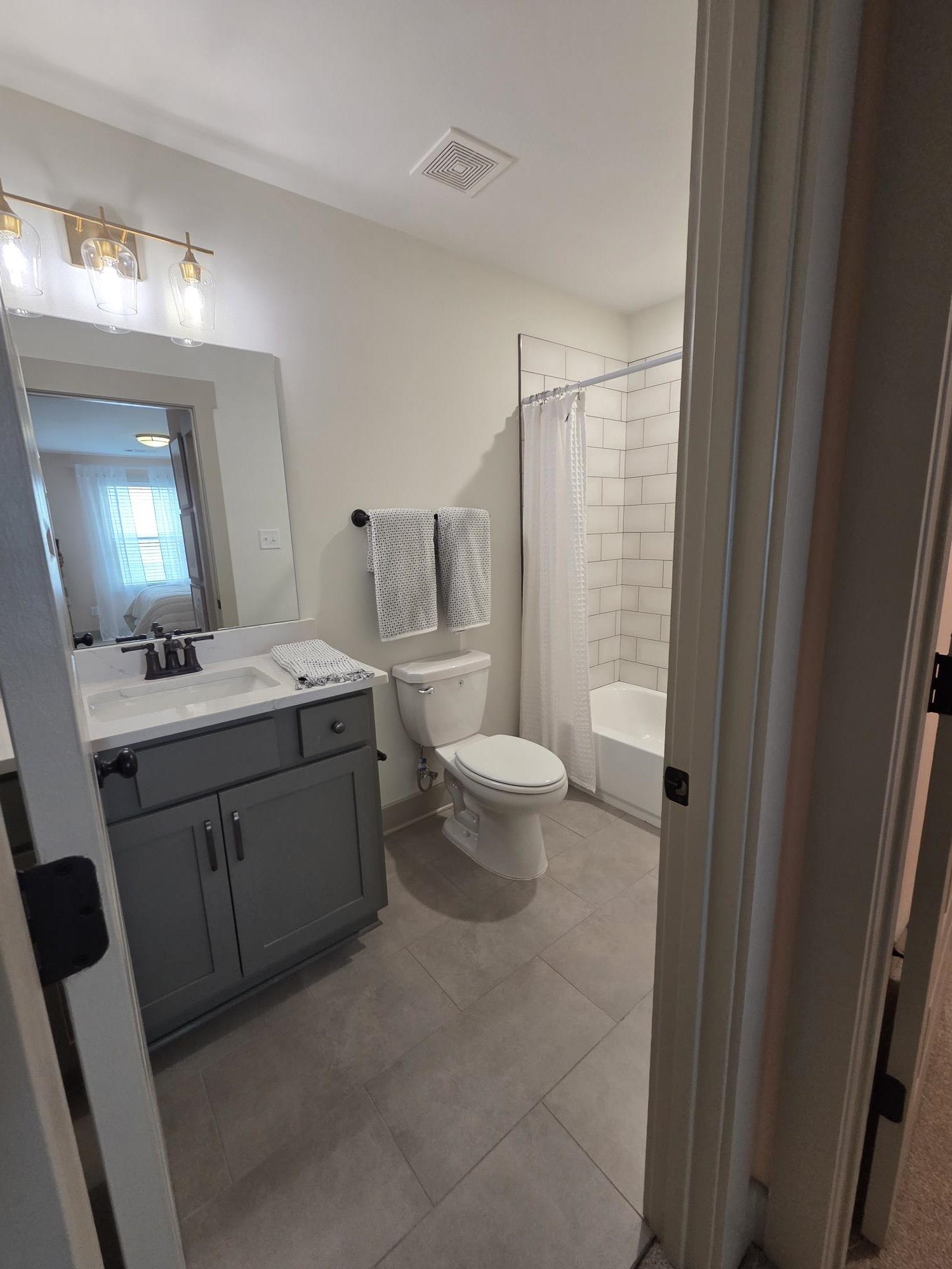 657 Mount Laurel Drive Collierville, TN 38017 - Photo 38 of 40 a bathroom with a double vanity sink mirror and toilet