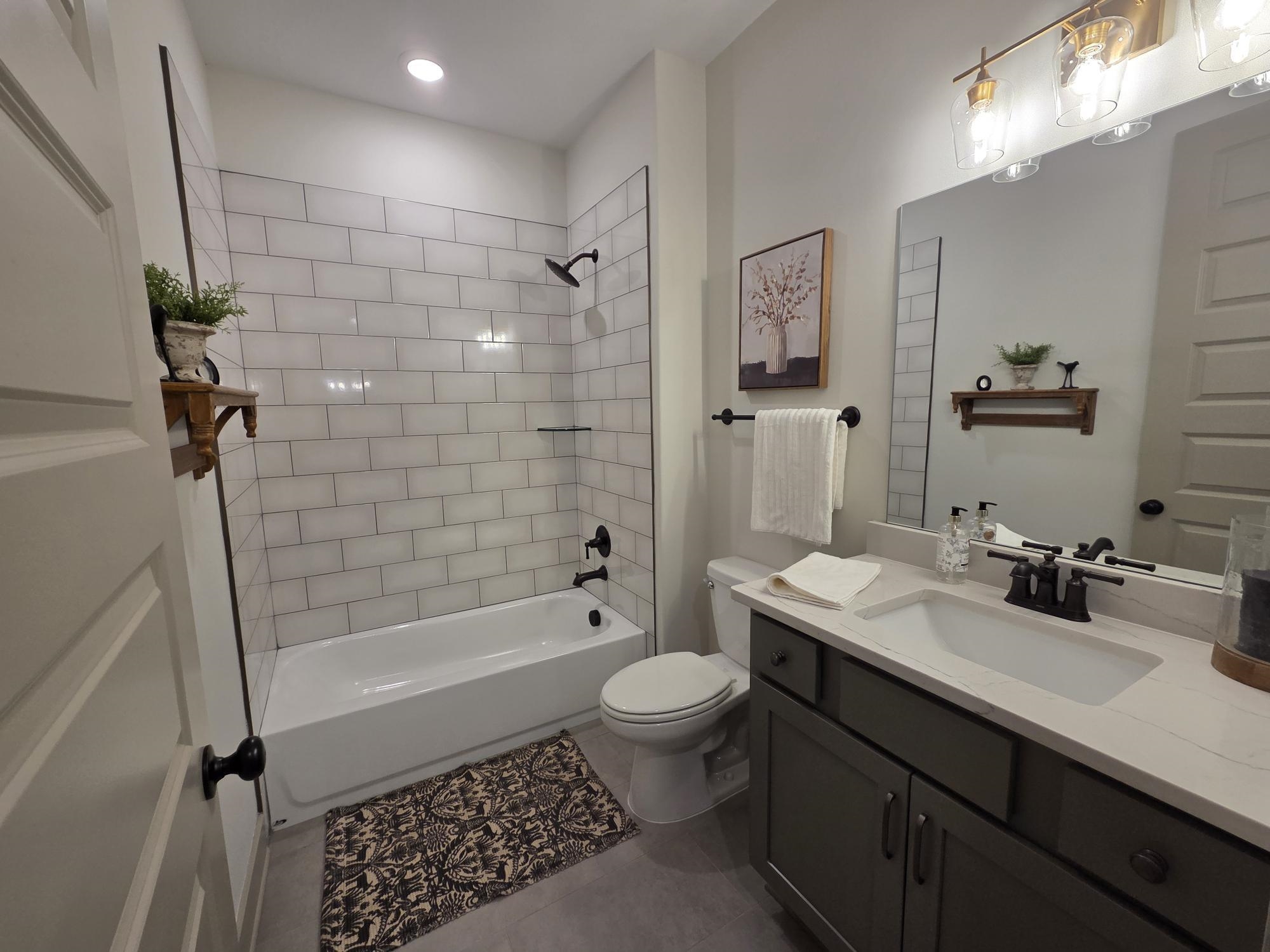 657 Mount Laurel Drive Collierville, TN 38017 - Photo 4 of 40 a bathroom with a sink a toilet and shower