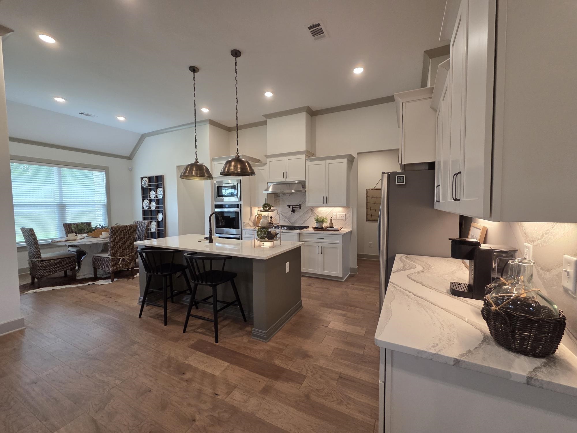 657 Mount Laurel Drive Collierville, TN 38017 - Photo 6 of 40 a kitchen with refrigerator a sink and chairs