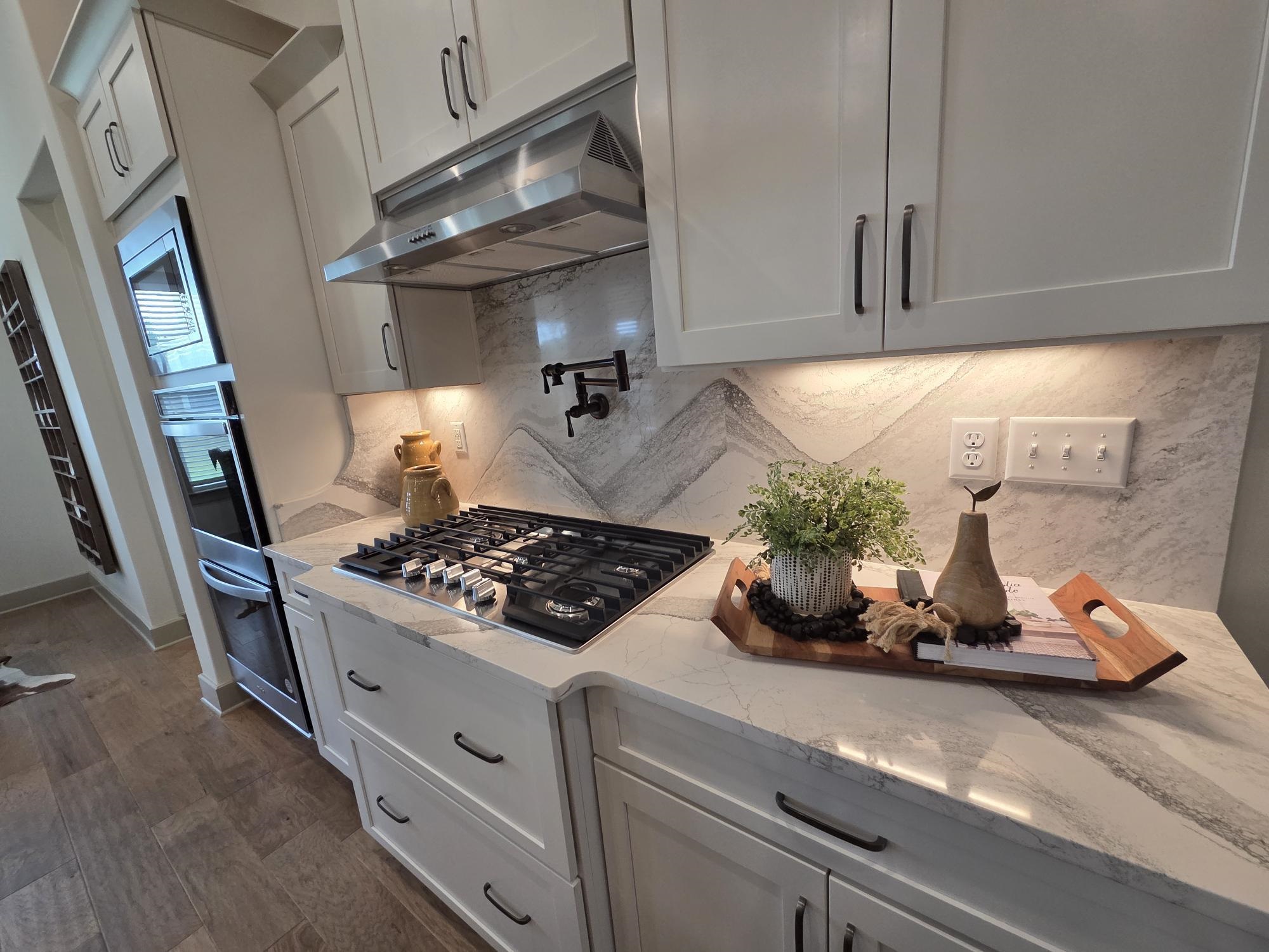 657 Mount Laurel Drive Collierville, TN 38017 - Photo 10 of 40 a kitchen with stainless steel appliances granite countertop a sink stove and cabinets