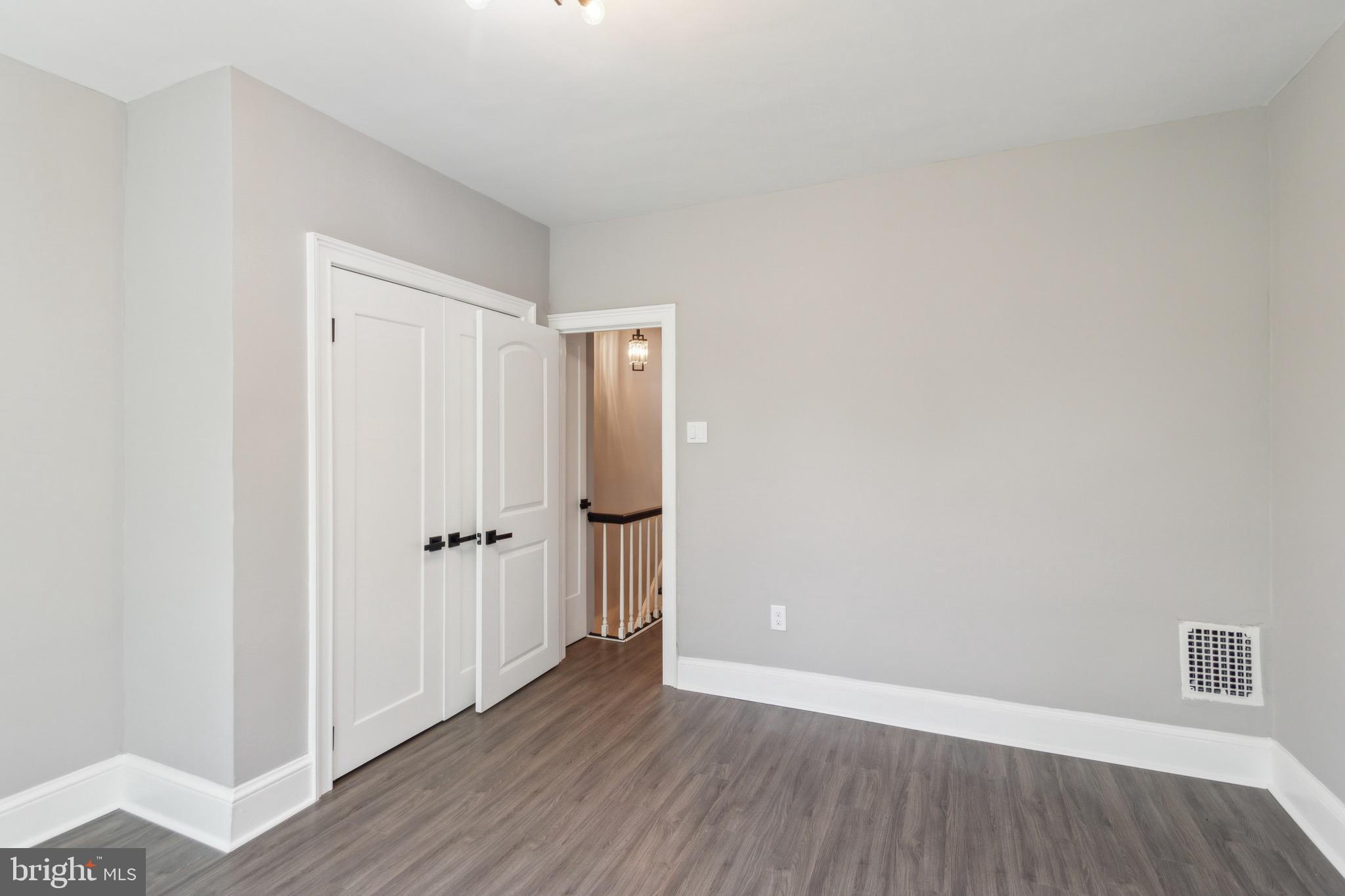 1613 Louis Street Camden, NJ 08104 - Photo 13 of 22 a view of an empty room with wooden floor
