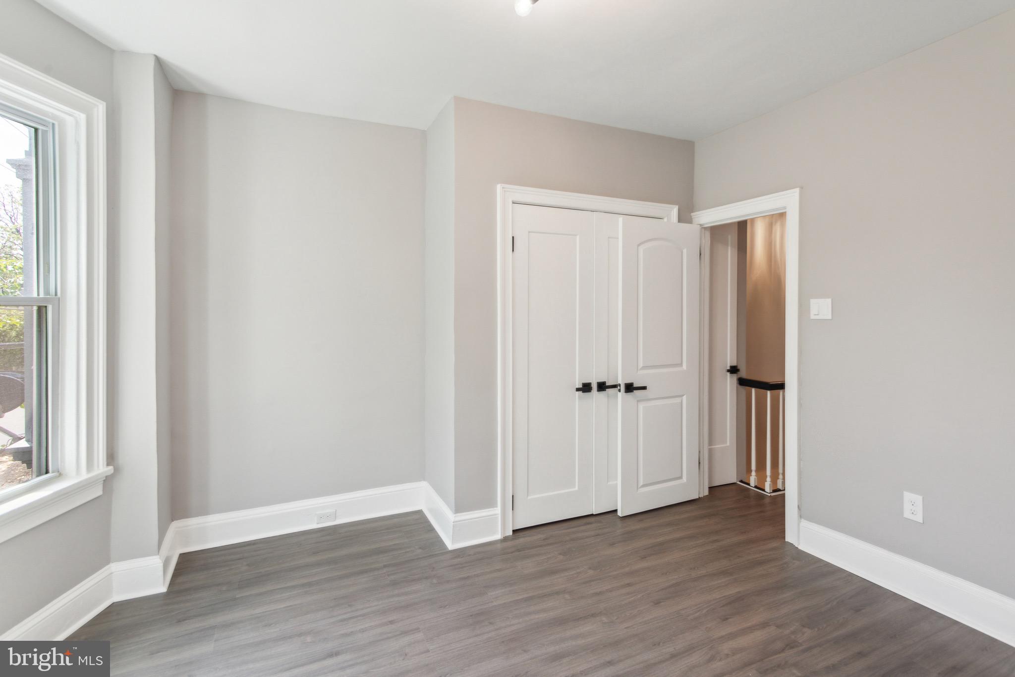 1613 Louis Street Camden, NJ 08104 - Photo 14 of 22 a view of an empty room with wooden floor