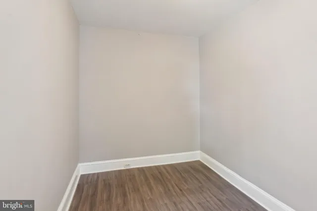 a view of a small space with wooden floor and a window