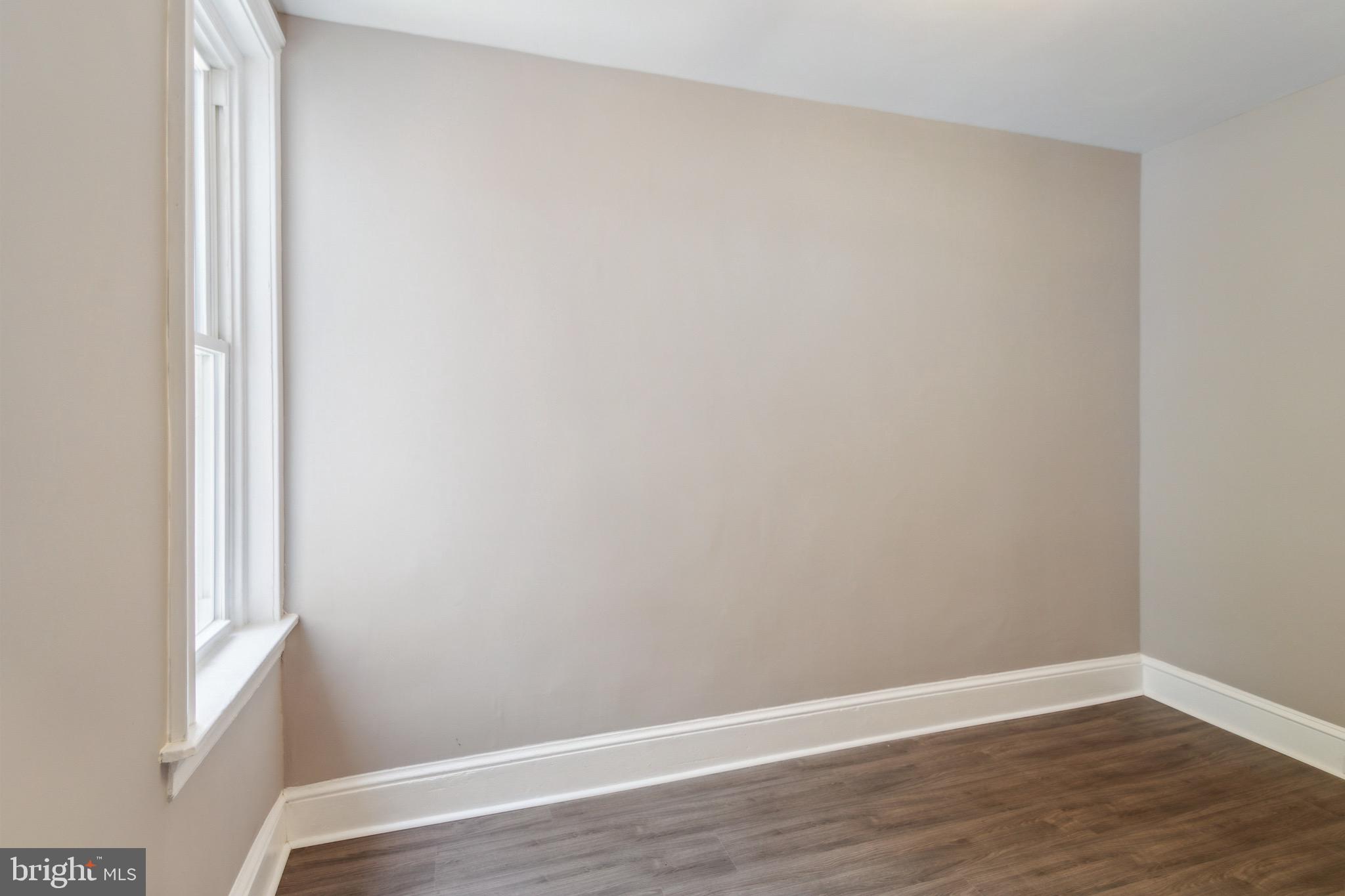 1613 Louis Street Camden, NJ 08104 - Photo 18 of 22 a view of a small space with wooden floor and a window