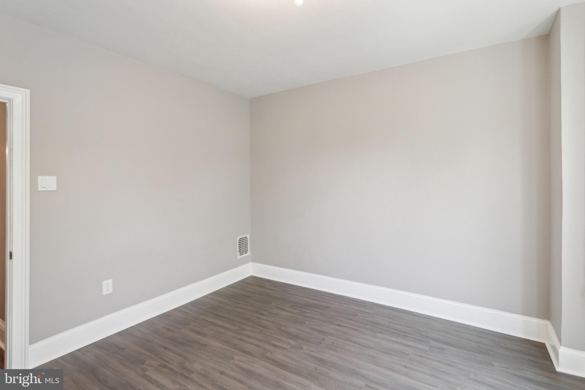 1613 Louis Street Camden, NJ 08104 - Photo 19 of 22 a view of an empty room with wooden floor