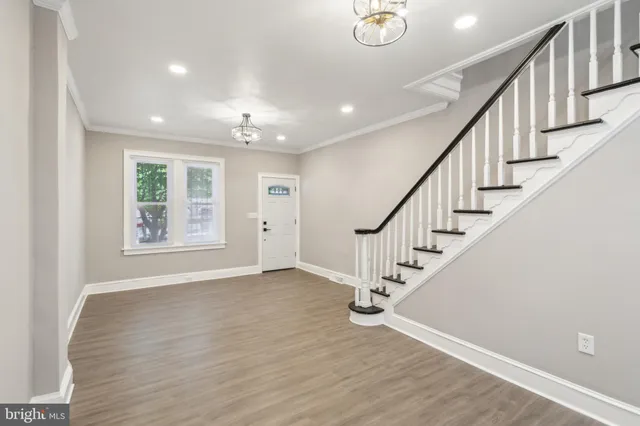 a view of an entryway with wooden floor