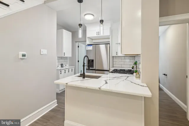 a kitchen with stainless steel appliances a sink and cabinets