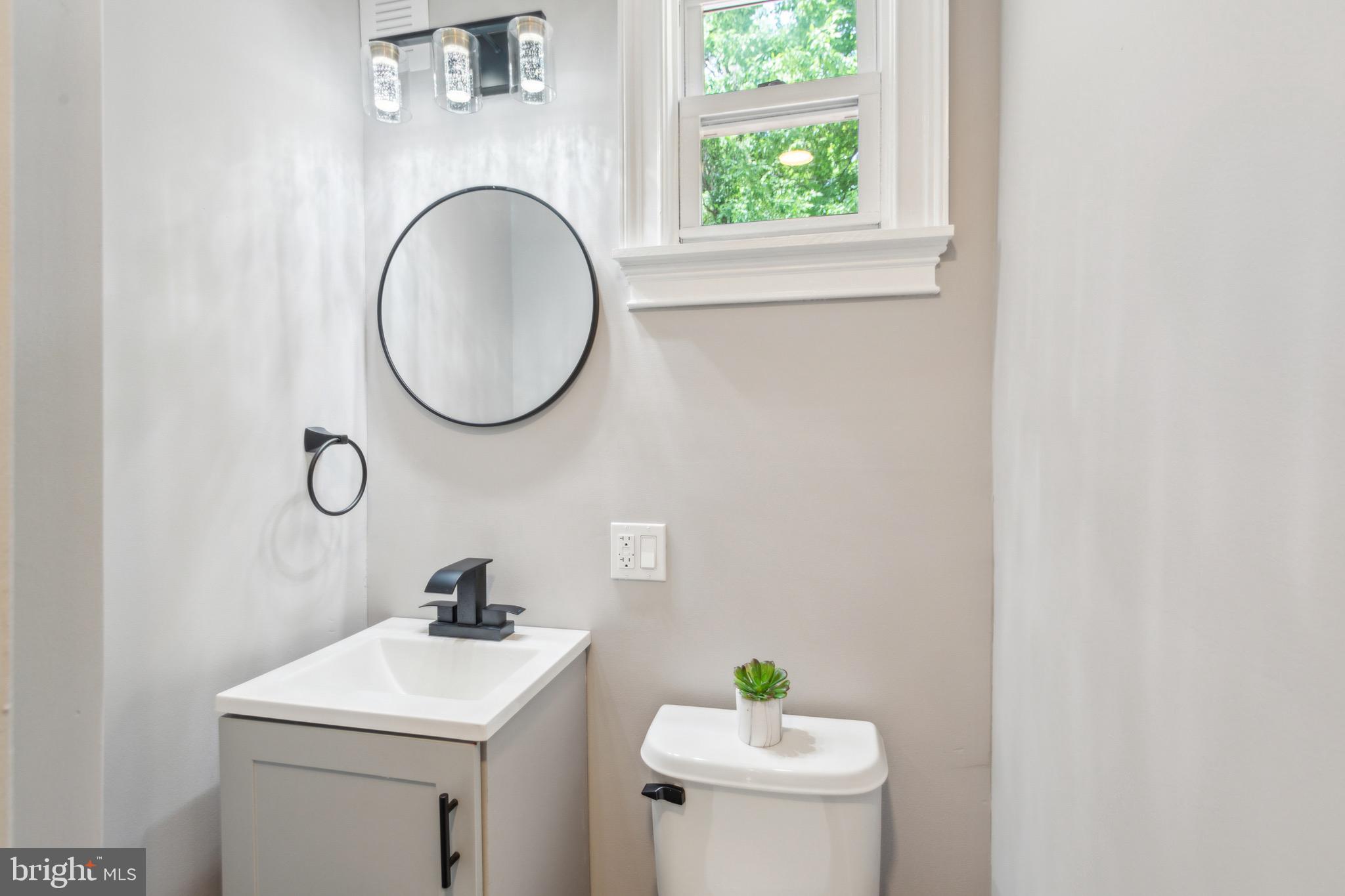 1613 Louis Street Camden, NJ 08104 - Photo 10 of 22 a bathroom with a sink a toilet and a mirror