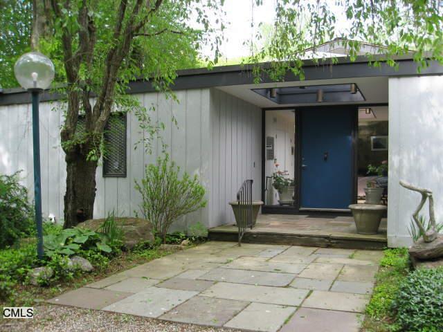 12 Cranbury Road Westport, CT 06880 - Photo 1 of 1 a front view of a house with a yard and trees