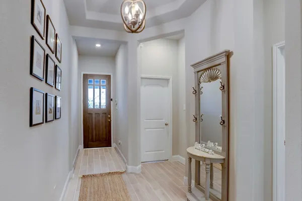 a kitchen with a stove a sink a microwave a dining table and chairs