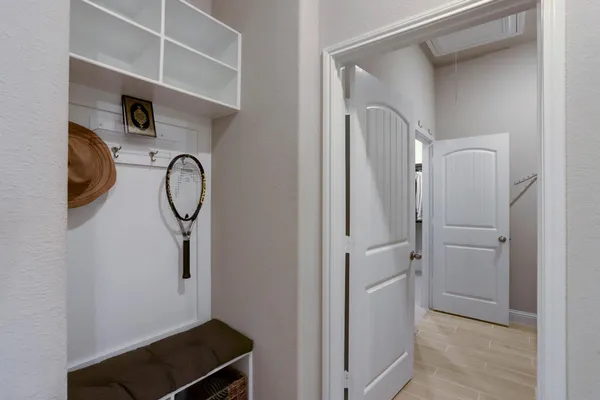 a living room with furniture kitchen view and a chandelier