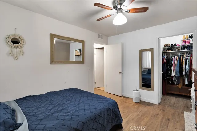 a bedroom with a large bed and a chandelier