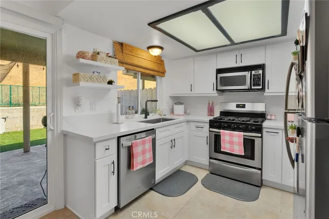 a kitchen with stainless steel appliances granite countertop a stove and a sink