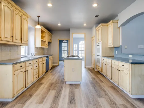 a kitchen with granite countertop a sink and cabinets