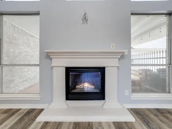 a kitchen with stainless steel appliances granite countertop a sink a stove a refrigerator and island with wooden floor